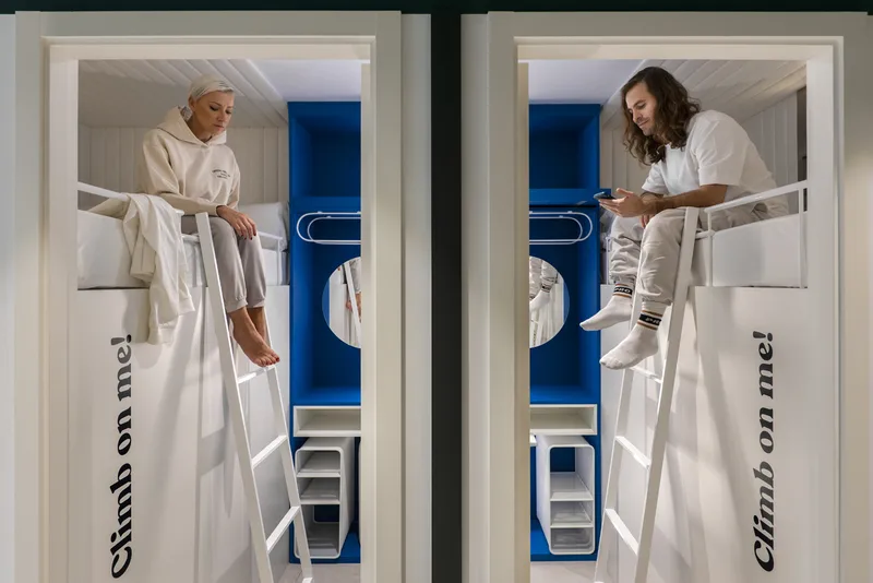 Compact sleeping space with built-in bedding, a ladder or fitted bedside storage.