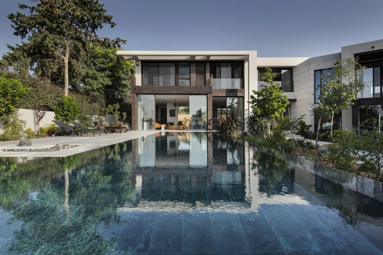 Swimming pool alongside the building and its outdoor spaces.