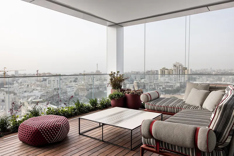 Balcony with outdoor seating overlooking the surroundings.