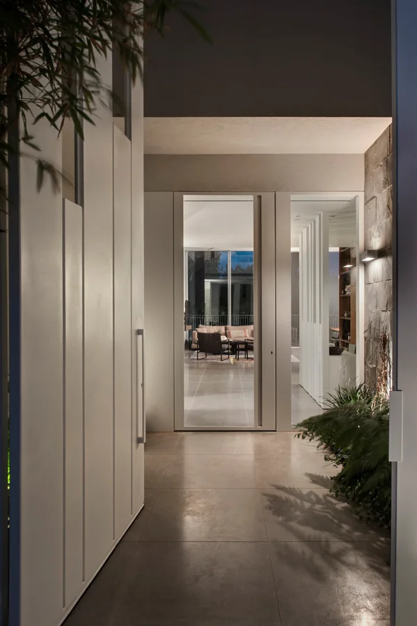 Interior passage showing doorways, walls and light from adjoining spaces.