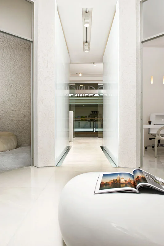 Interior passage showing doorways, walls and light from adjoining spaces.