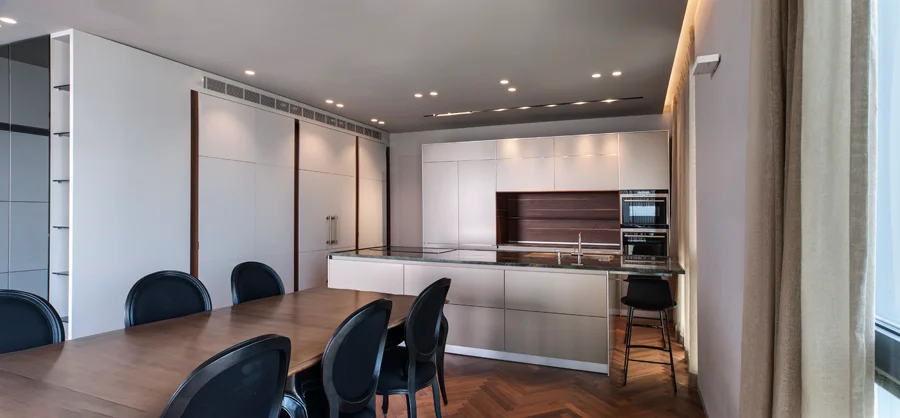 Dining space showing the table, chairs and overhead lighting.
