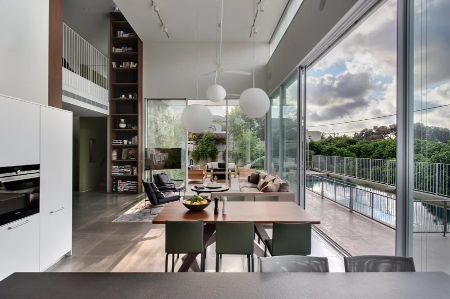Dining space showing the table, chairs and overhead lighting.