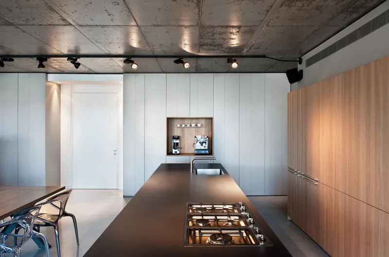 Dining space showing the table, chairs and overhead lighting.