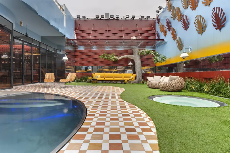 Swimming pool alongside the building and its outdoor spaces.