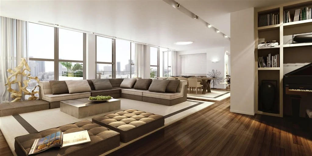 Living room with seating, tables and large windows.
