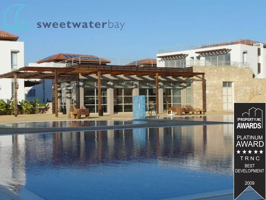 Swimming pool alongside the building and its outdoor spaces.