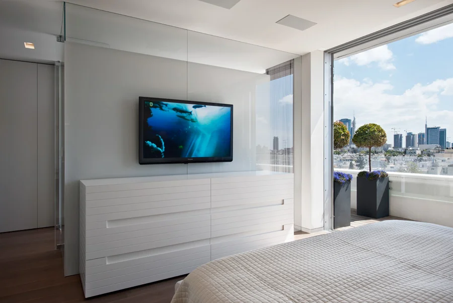 Living-space detail showing a television wall and fitted furnishings.
