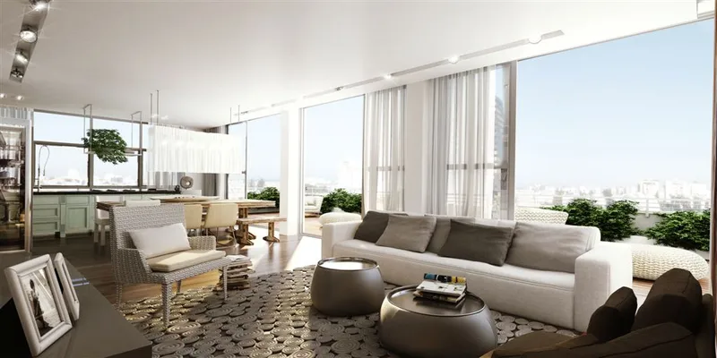 Living room with seating, tables and large windows.