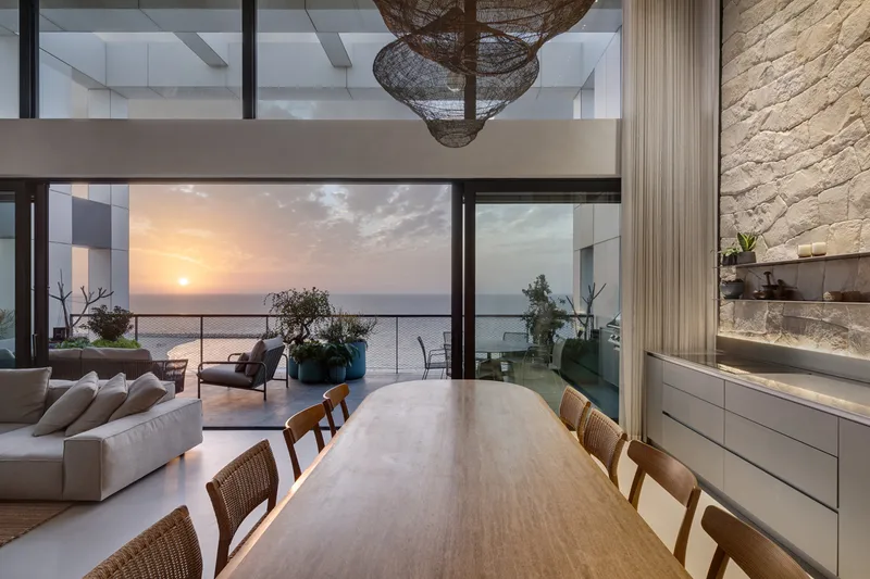 Dining space showing the table, chairs and overhead lighting.