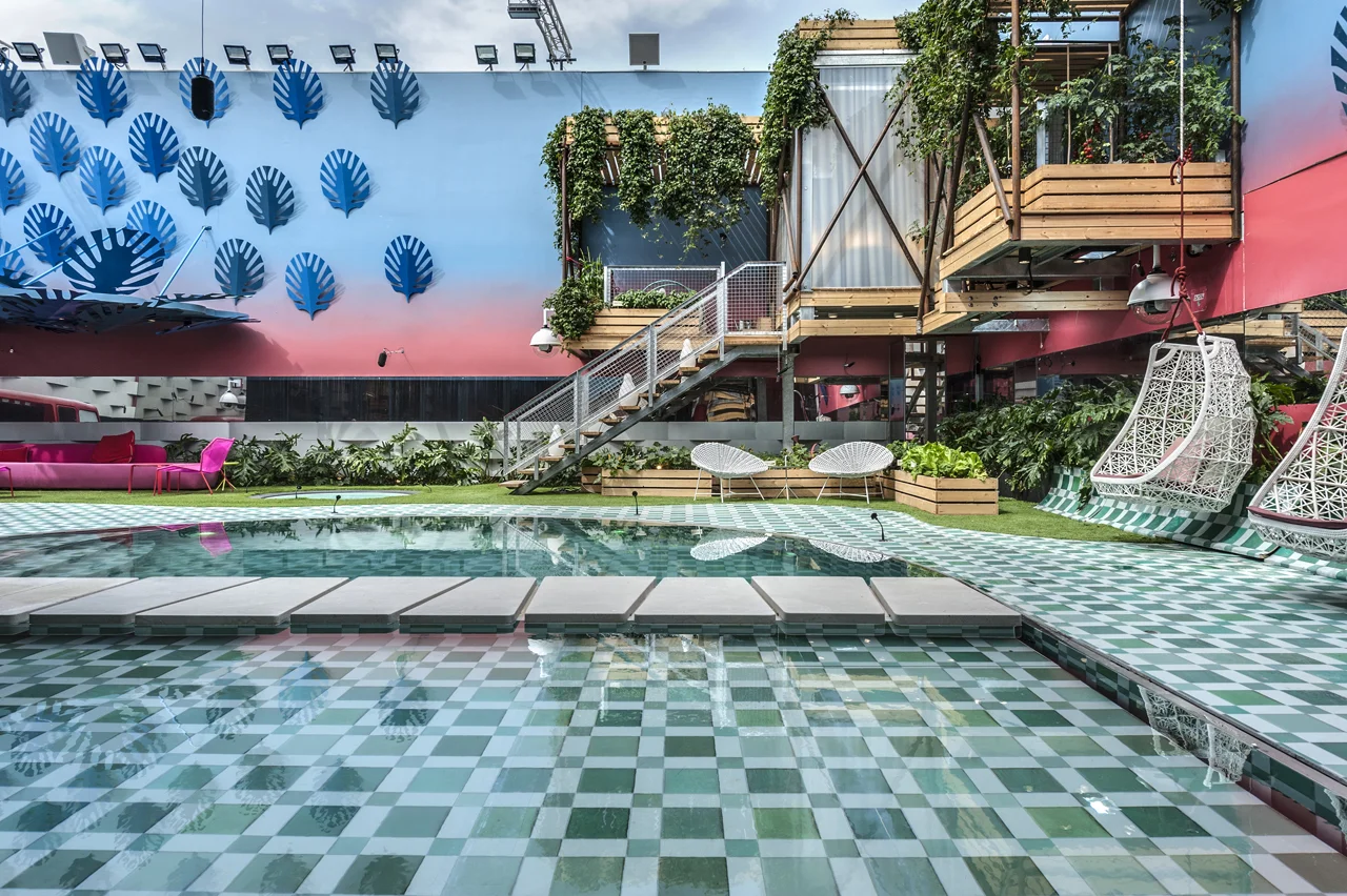 Swimming pool alongside the building and its outdoor spaces.
