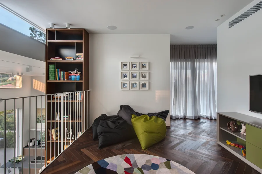 Interior seating area with sofas, tables and decorative wall and ceiling finishes.