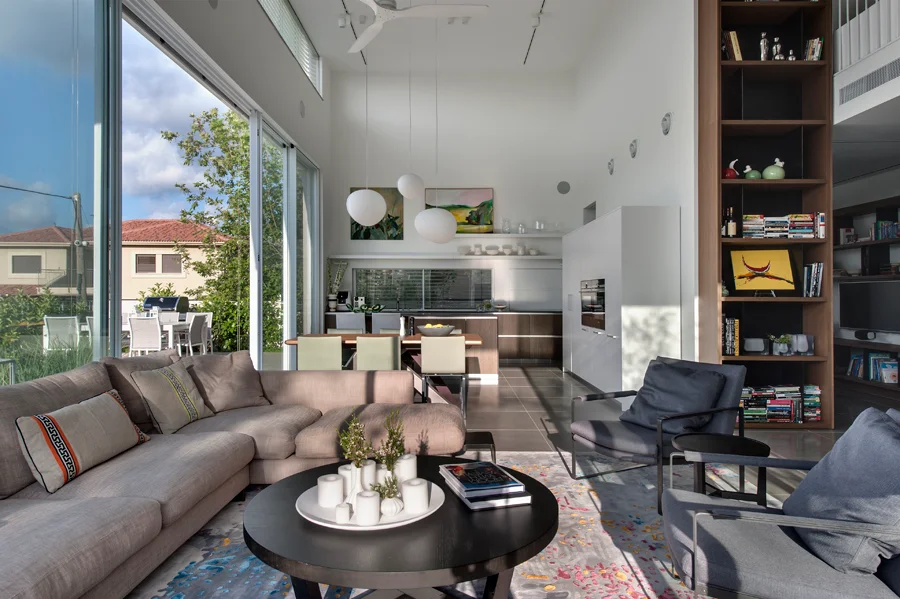 Living room with seating, tables and large windows.