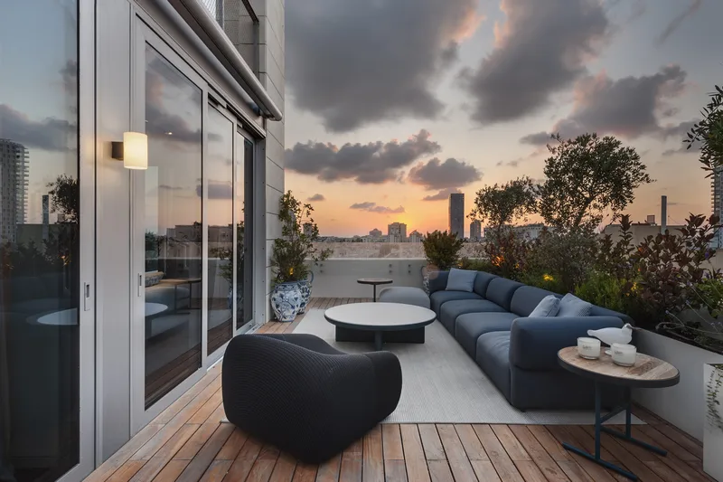 Balcony with outdoor seating overlooking the surroundings.