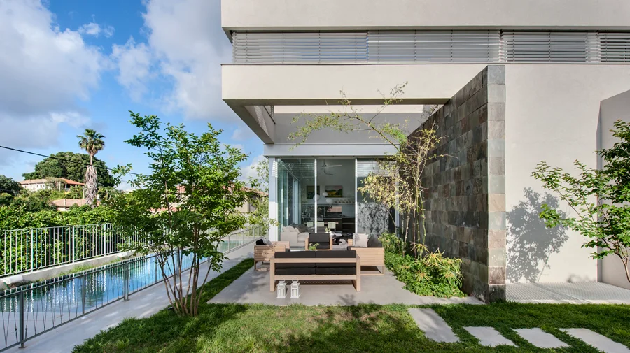 Swimming pool alongside the building and its outdoor spaces.