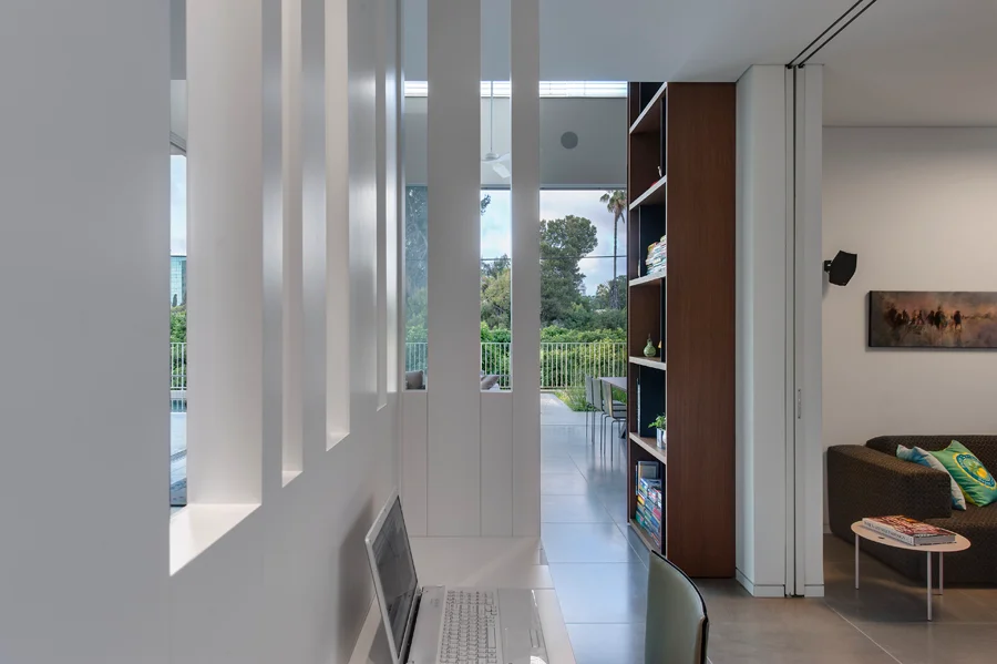 Interior passage showing doorways, walls and light from adjoining spaces.
