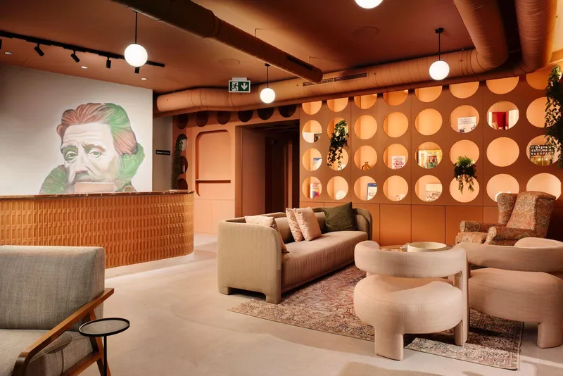 Interior seating area with sofas, tables and decorative wall and ceiling finishes.