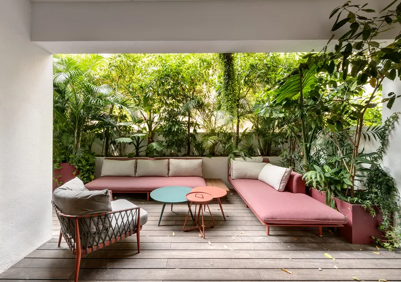 Balcony with outdoor seating overlooking the surroundings.