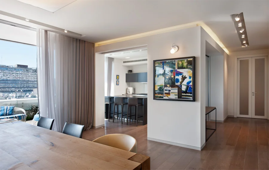 Dining space showing the table, chairs and overhead lighting.