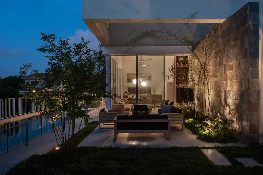 Exterior view at dusk or night, with illuminated spaces.