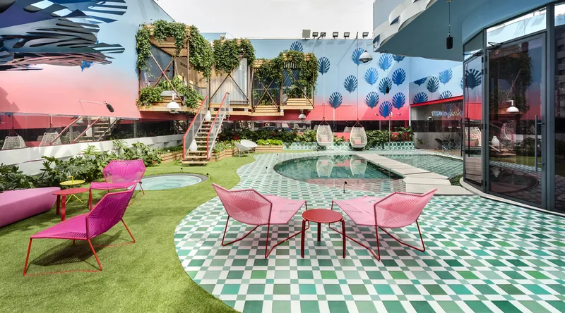 Planted courtyard with a seating area beside the building.