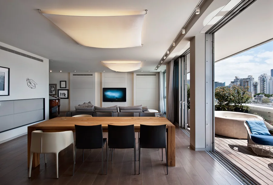Dining space showing the table, chairs and overhead lighting.